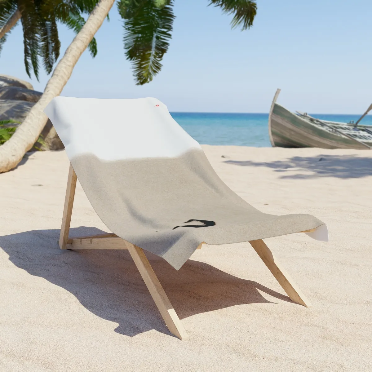 White-and-sand-colored beach towel with small red and large black question marks.